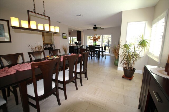 dining area featuring visible vents, ceiling fan, and baseboards