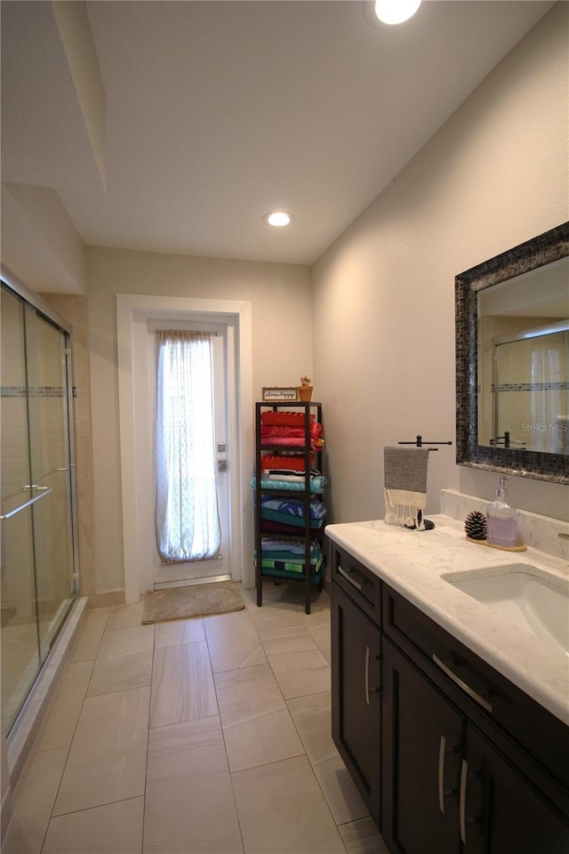 bathroom with recessed lighting, a shower stall, and vanity