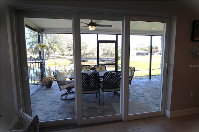 doorway to outside with ceiling fan