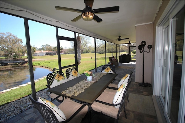 sunroom with plenty of natural light and a water view