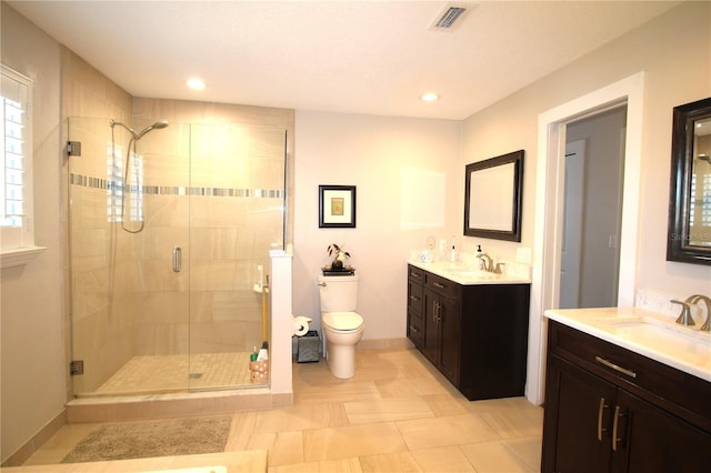 bathroom with a sink, visible vents, and a shower stall