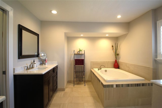 bathroom featuring tile patterned floors, a garden tub, vanity, and recessed lighting