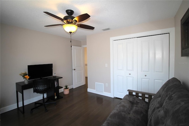 office space featuring ceiling fan, wood finished floors, visible vents, and baseboards