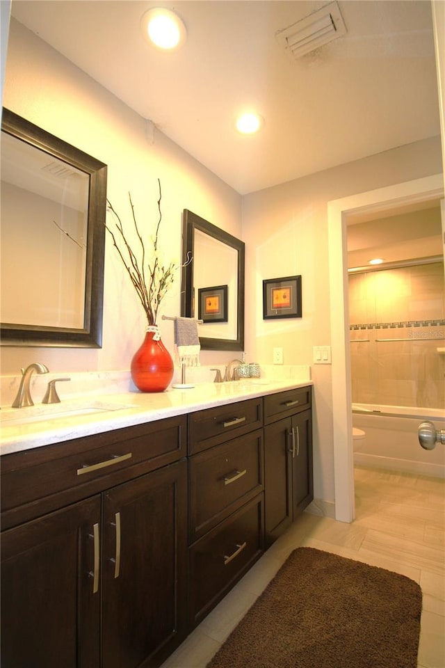 full bathroom featuring double vanity, visible vents, toilet, a sink, and recessed lighting