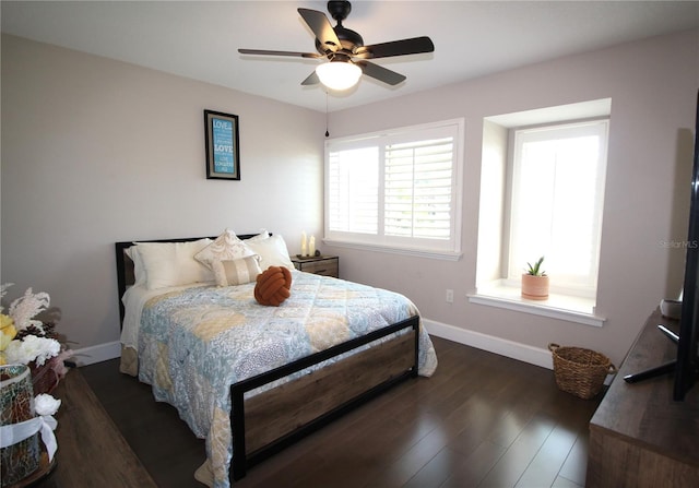 bedroom with a ceiling fan, baseboards, and wood finished floors