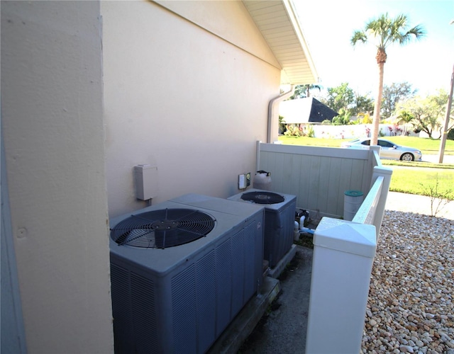 exterior details with central AC and stucco siding