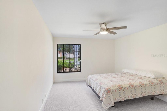 bedroom featuring light colored carpet and ceiling fan