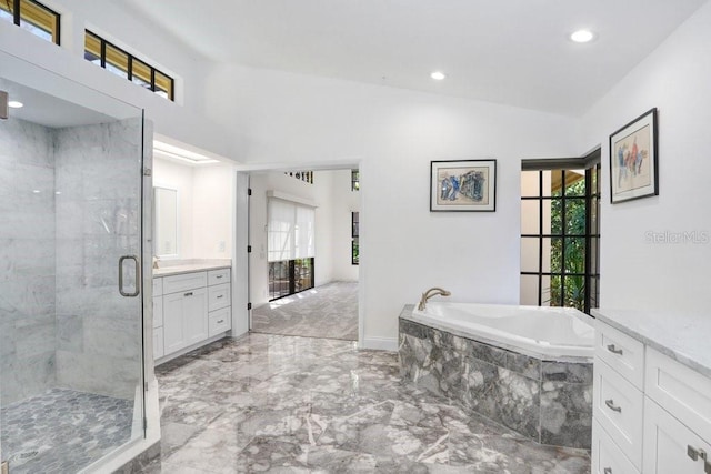 bathroom featuring plenty of natural light, vanity, independent shower and bath, and lofted ceiling