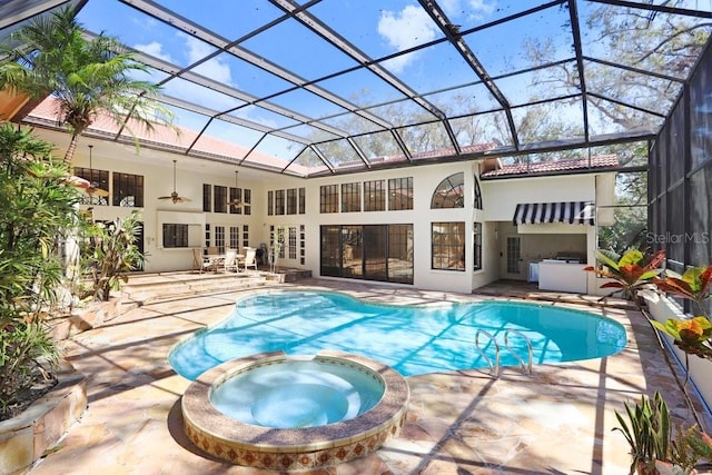 view of pool with a patio, a lanai, and an in ground hot tub