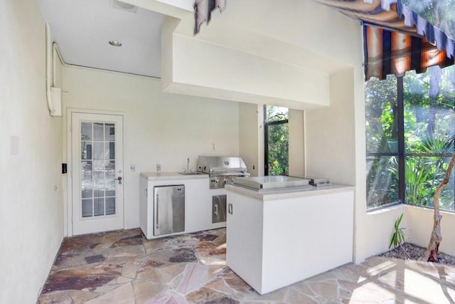 view of patio with area for grilling, exterior kitchen, and sink