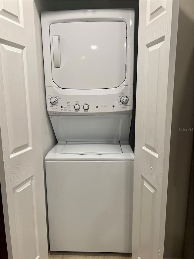 laundry area with stacked washing maching and dryer