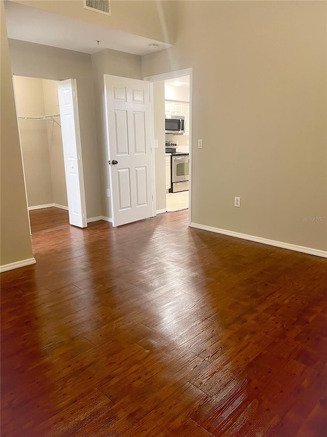 empty room featuring dark hardwood / wood-style floors