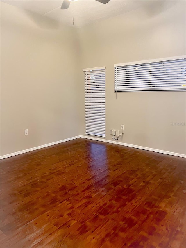 unfurnished room with ceiling fan and dark hardwood / wood-style flooring