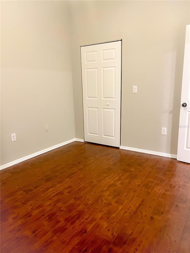 spare room with dark hardwood / wood-style flooring