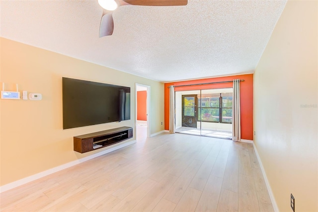 unfurnished living room featuring light hardwood / wood-style floors and a textured ceiling