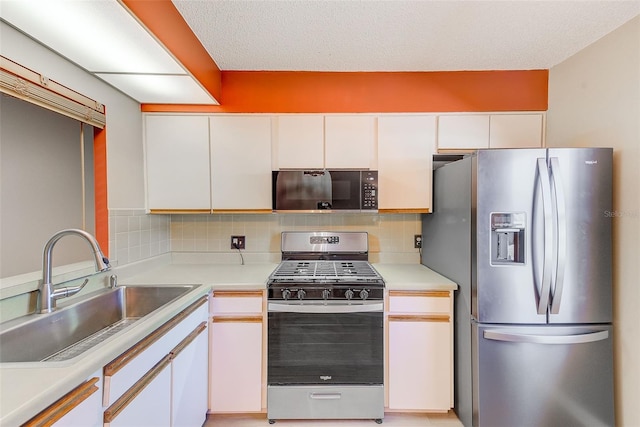 kitchen featuring white cabinetry, appliances with stainless steel finishes, sink, and tasteful backsplash