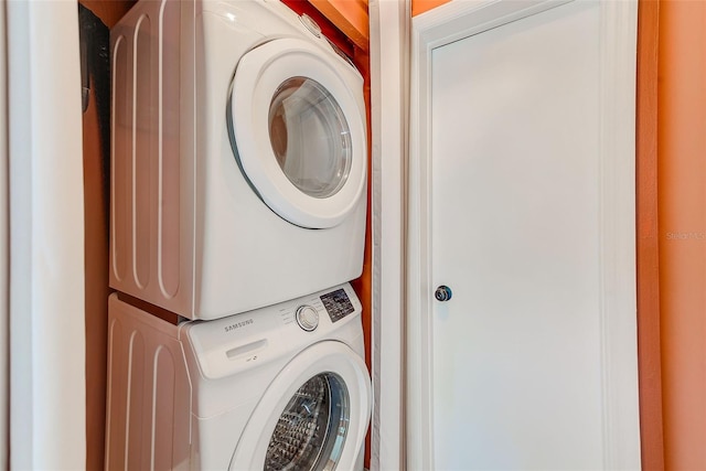 clothes washing area with stacked washer / dryer