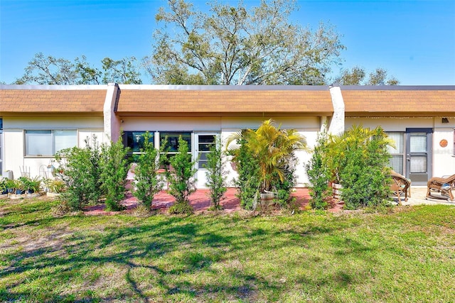 rear view of property with a lawn