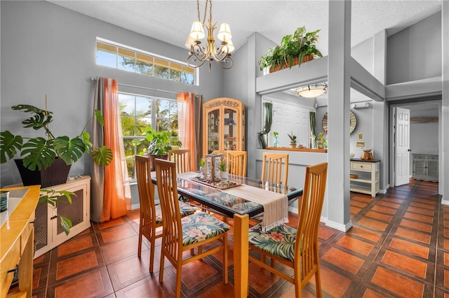13542 Summerwood Ct, Hudson, FL 34667 - dining room featuring a textured ceiling, a high ceiling, and a notable chandelier