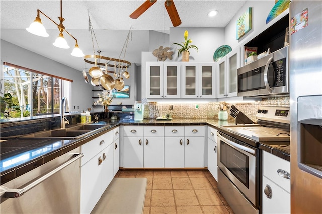 13542 Summerwood Ct, Hudson, FL 34667 - kitchen with tasteful backsplash, stainless steel appliances, white cabinets, decorative light fixtures, and sink