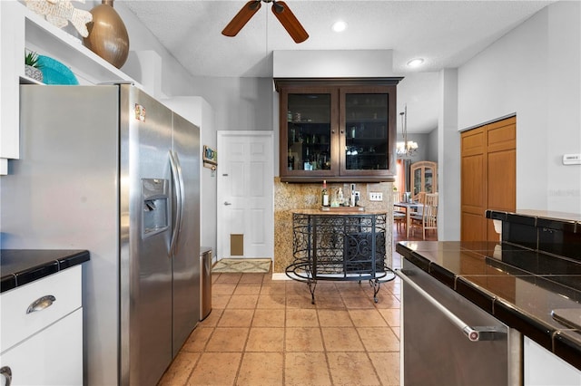 13542 Summerwood Ct, Hudson, FL 34667 - kitchen with dark brown cabinets, stainless steel appliances, decorative backsplash, decorative light fixtures, and ceiling fan
