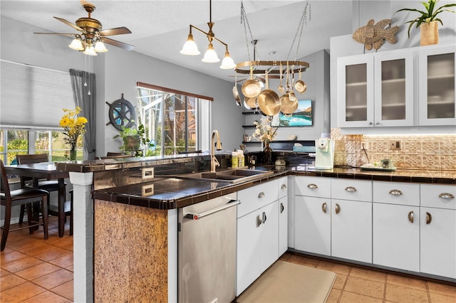 13542 Summerwood Ct, Hudson, FL 34667 - kitchen featuring hanging light fixtures, white cabinets, backsplash, sink, and kitchen peninsula