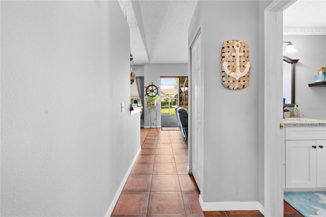 13542 Summerwood Ct, Hudson, FL 34667 - corridor with tile patterned floors, sink, and a textured ceiling