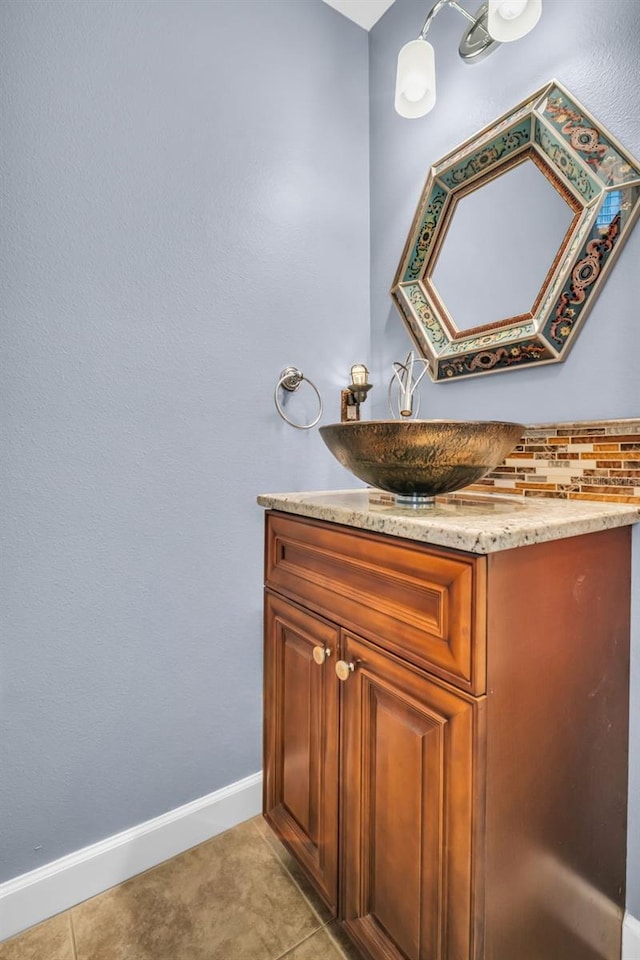 bathroom with tile patterned flooring, baseboards, and vanity