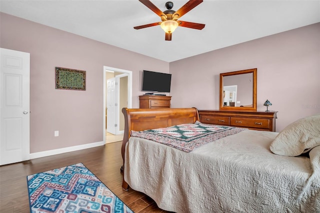 bedroom featuring dark wood finished floors, a ceiling fan, and baseboards