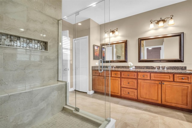 bathroom featuring a closet, a shower stall, and double vanity