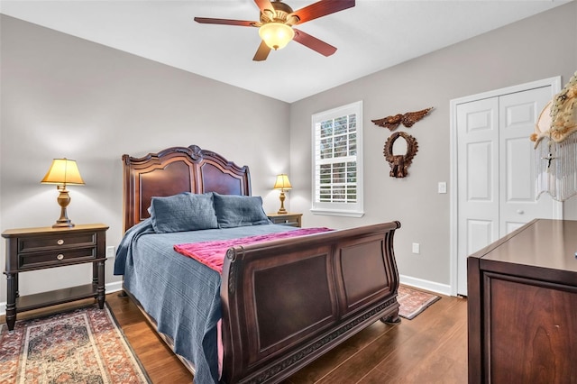 bedroom featuring ceiling fan, dark wood-type flooring, a closet, and baseboards