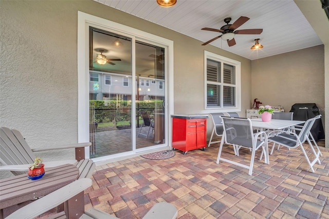 view of patio / terrace featuring outdoor dining space and a ceiling fan