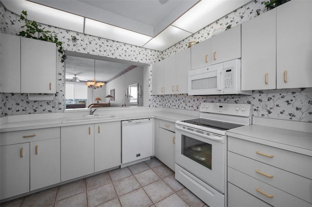 kitchen with white appliances, sink, light tile patterned flooring, white cabinets, and decorative backsplash