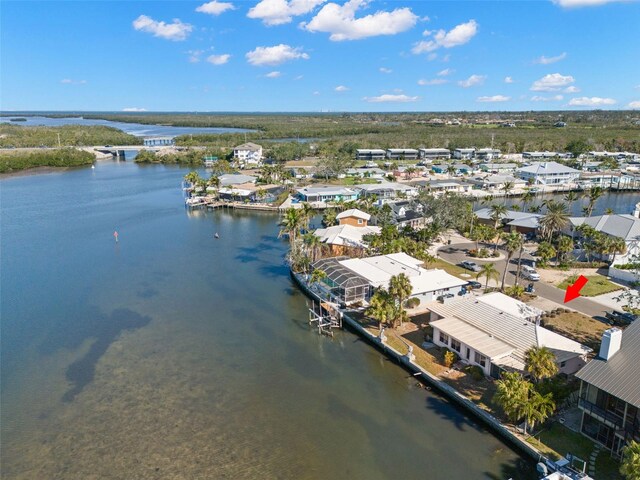 birds eye view of property with a water view and a residential view