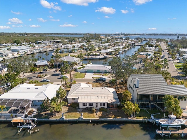 drone / aerial view with a water view and a residential view