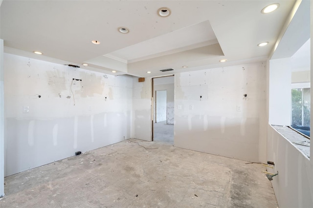 empty room featuring recessed lighting and a tray ceiling