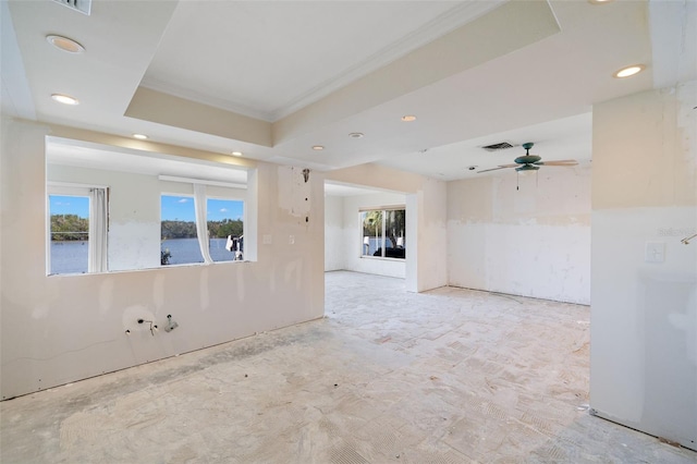 spare room featuring recessed lighting, a raised ceiling, a water view, visible vents, and ceiling fan