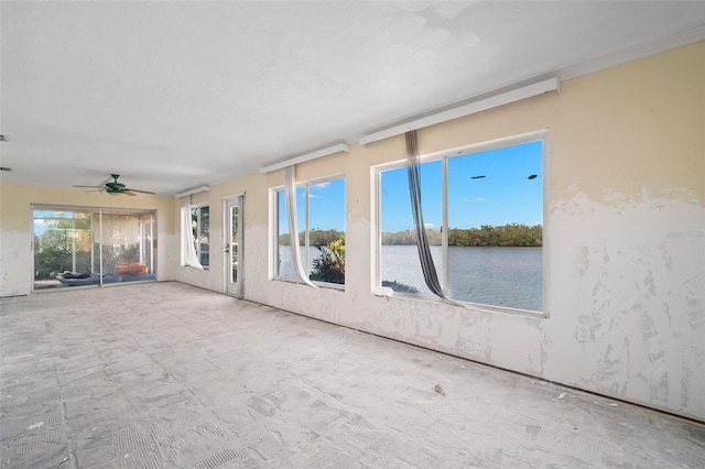 spare room featuring a water view and a sunroom