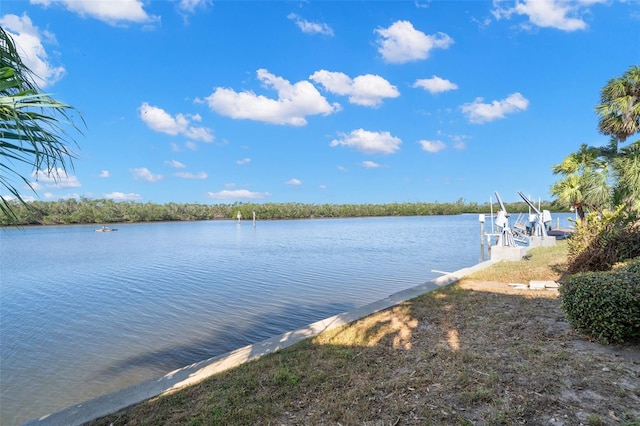 property view of water featuring a boat dock and boat lift