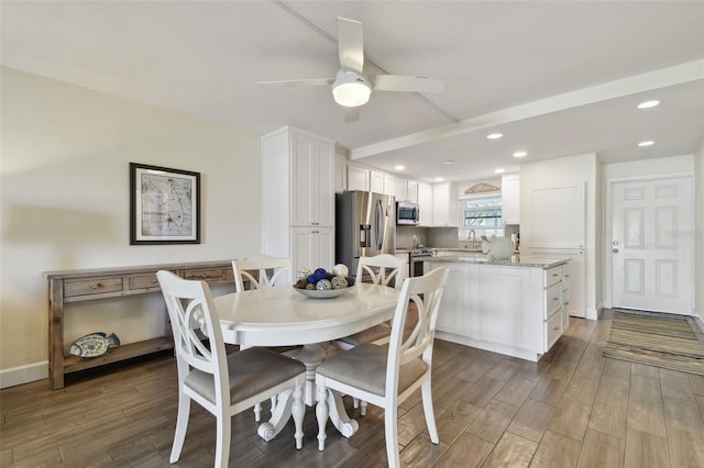 3717 46th Ave S Unit 7, Saint Petersburg, FL 33711 - dining space with ceiling fan, sink, and dark wood-type flooring