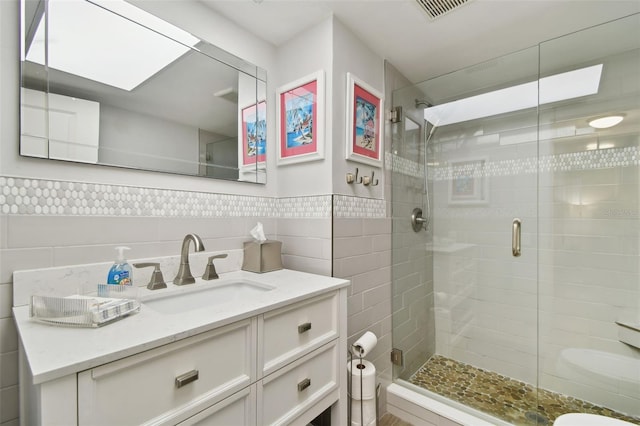 3717 46th Ave S Unit 7, Saint Petersburg, FL 33711 - bathroom with tile walls, vanity, and a shower with door