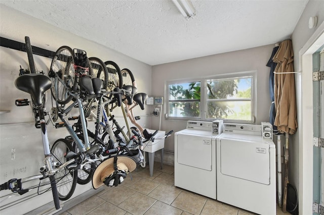 3717 46th Ave S Unit 7, Saint Petersburg, FL 33711 - clothes washing area with light tile patterned flooring, washing machine and dryer, and a textured ceiling