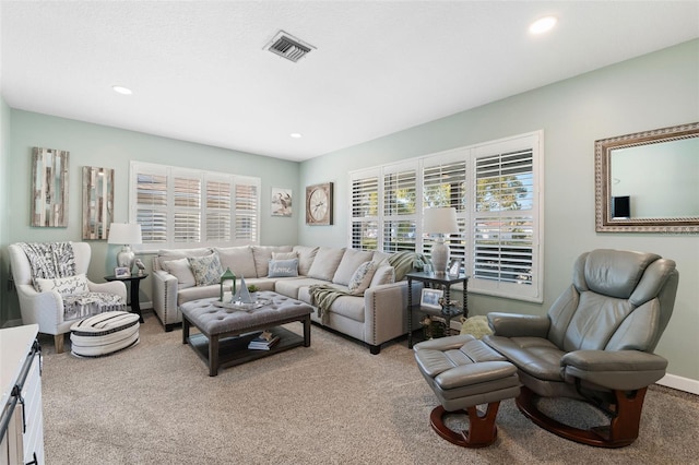 living room featuring recessed lighting, visible vents, plenty of natural light, and light carpet