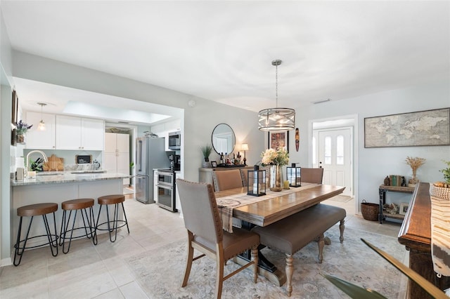 dining space with visible vents and light tile patterned floors