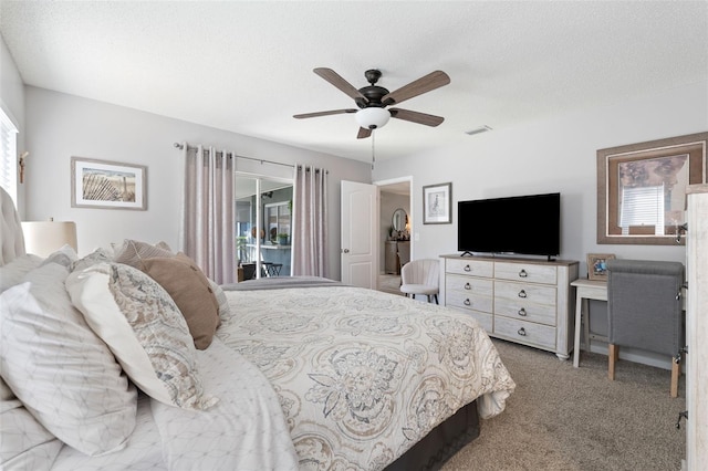 bedroom with carpet floors, access to exterior, visible vents, and a textured ceiling