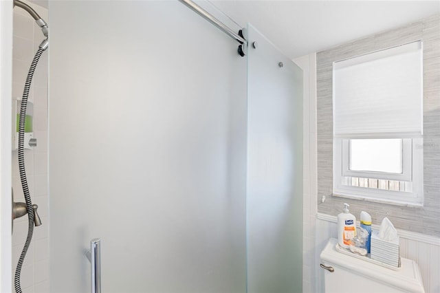 bathroom with a shower stall and toilet