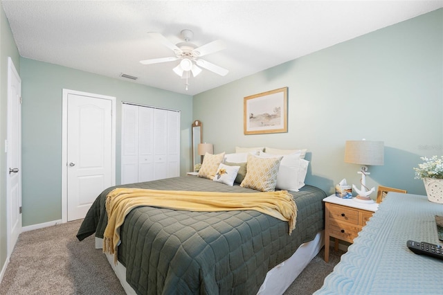 carpeted bedroom with baseboards, visible vents, and a ceiling fan