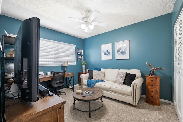 office space featuring ceiling fan, a textured ceiling, and baseboards