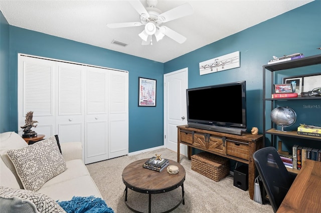 living area with a ceiling fan, visible vents, light carpet, and baseboards