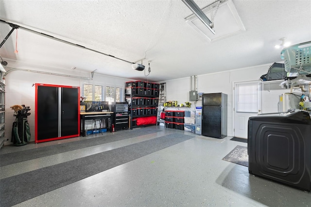 garage with washer / clothes dryer, freestanding refrigerator, and a garage door opener